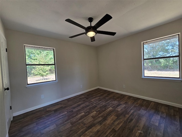 unfurnished room featuring ceiling fan and dark wood-type flooring