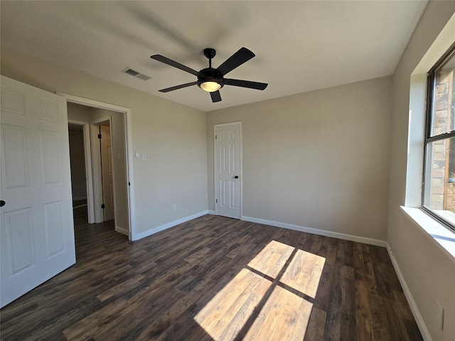 empty room featuring ceiling fan and dark hardwood / wood-style floors