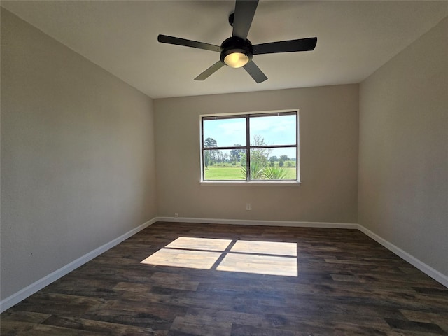 empty room with ceiling fan and dark hardwood / wood-style flooring