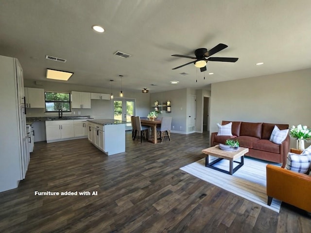 living room featuring dark wood-type flooring, ceiling fan, and sink