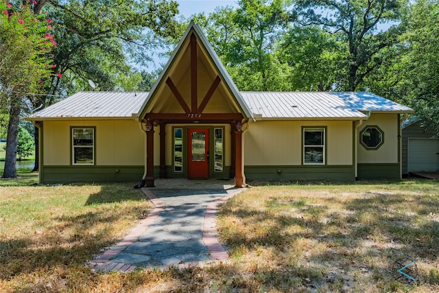 view of front of property with covered porch and a front yard