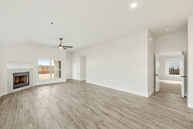 unfurnished living room with ceiling fan, a healthy amount of sunlight, and light wood-type flooring