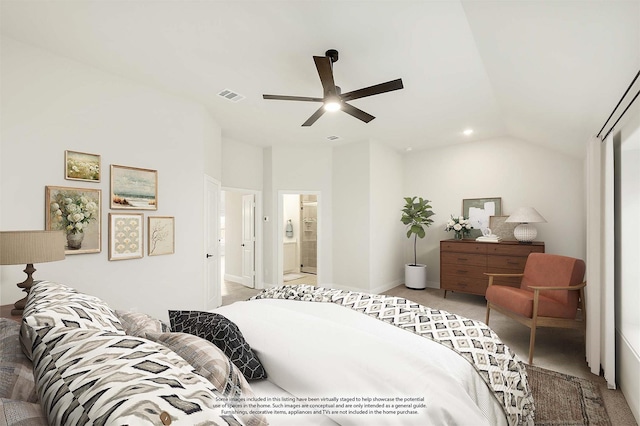 bedroom featuring light carpet, ensuite bath, vaulted ceiling, and ceiling fan