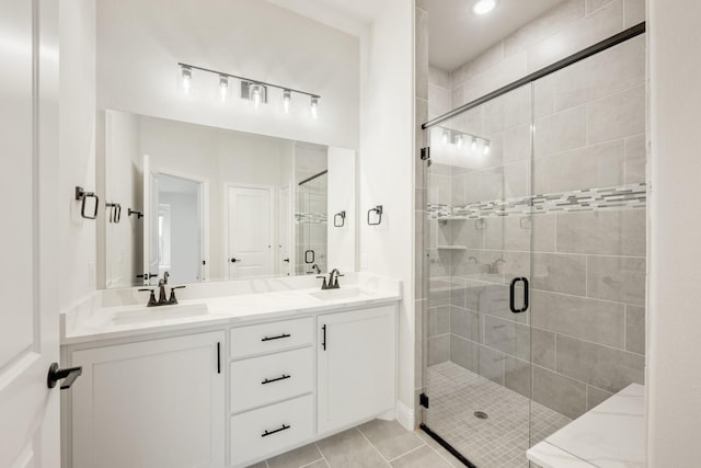 bathroom featuring tile patterned flooring, vanity, and a shower with door