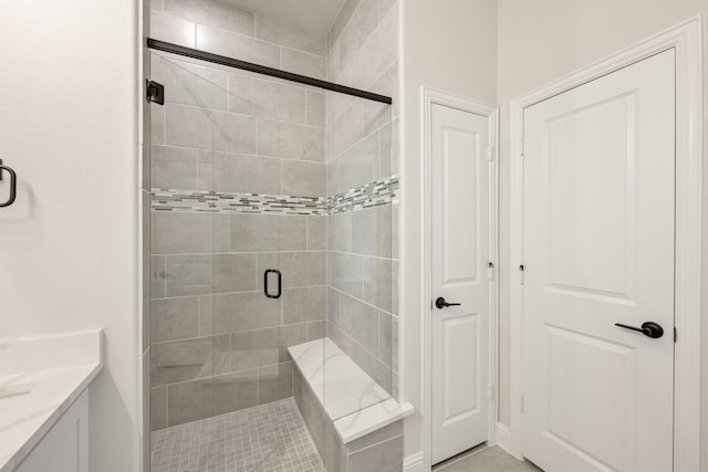 bathroom featuring walk in shower and vanity