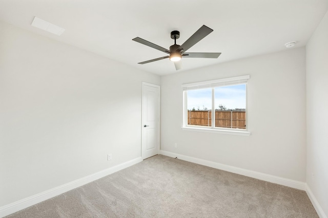 empty room with ceiling fan and light colored carpet