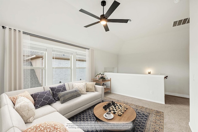 living room with ceiling fan, vaulted ceiling, and light carpet