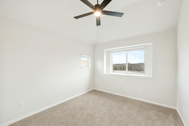 spare room with ceiling fan, light colored carpet, and lofted ceiling