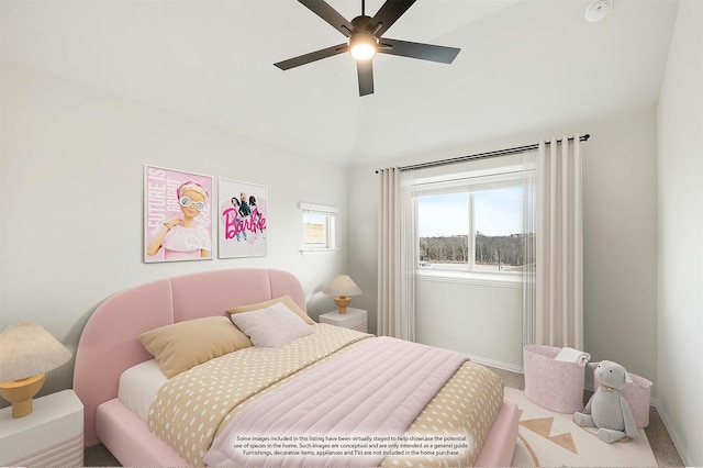 bedroom with ceiling fan, lofted ceiling, and carpet floors