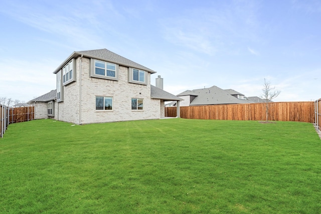 back of house featuring a yard