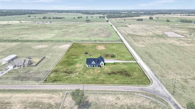 birds eye view of property with a rural view