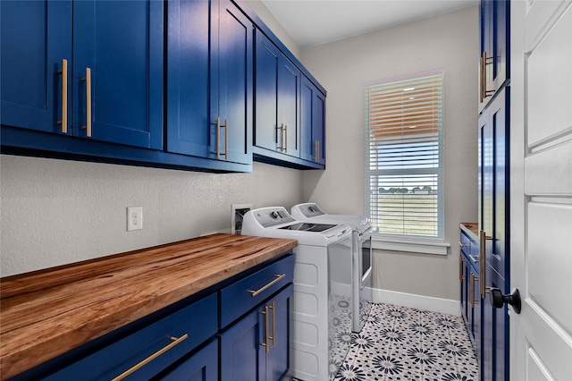 laundry area with a textured wall, cabinet space, independent washer and dryer, and baseboards