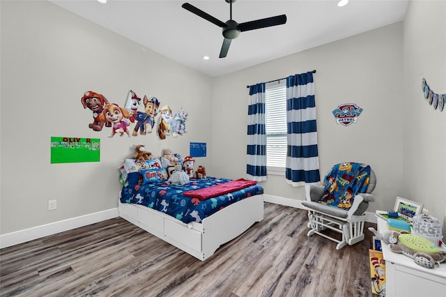 bedroom with ceiling fan, baseboards, and wood finished floors