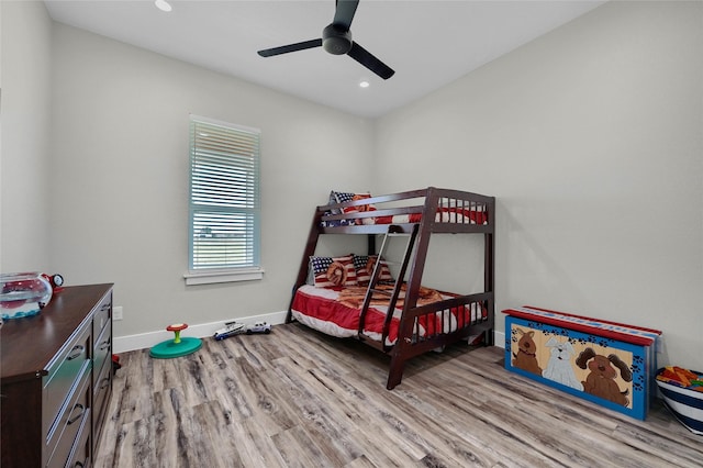 bedroom featuring a ceiling fan, recessed lighting, baseboards, and wood finished floors