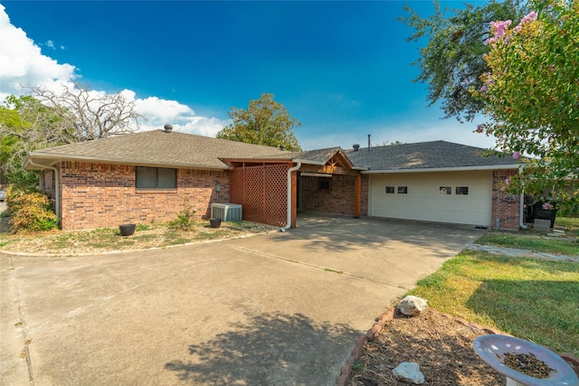 single story home with a garage, concrete driveway, and brick siding