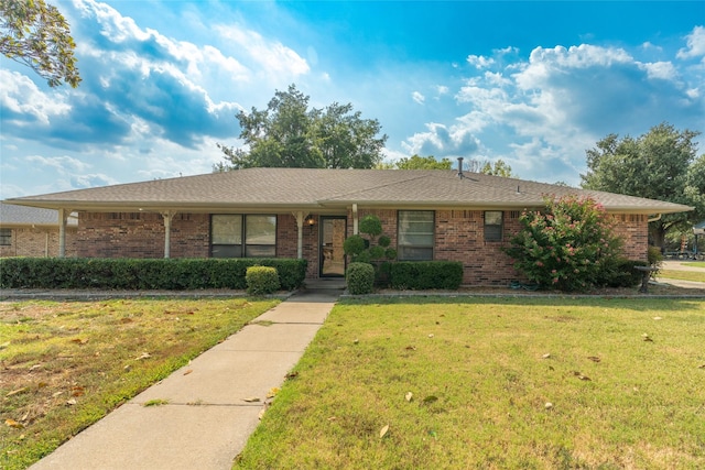 ranch-style home with brick siding and a front yard