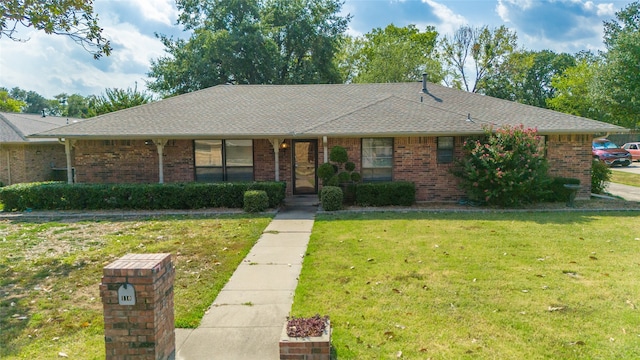 ranch-style home featuring a front yard