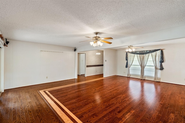 spare room featuring a textured ceiling, ceiling fan, and wood finished floors