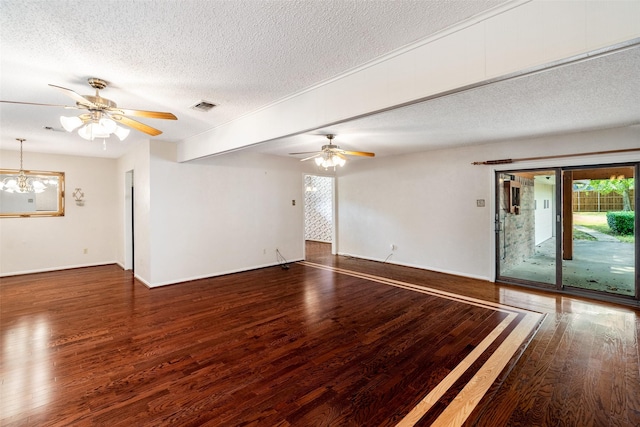 empty room featuring a textured ceiling, ceiling fan with notable chandelier, wood finished floors, visible vents, and baseboards