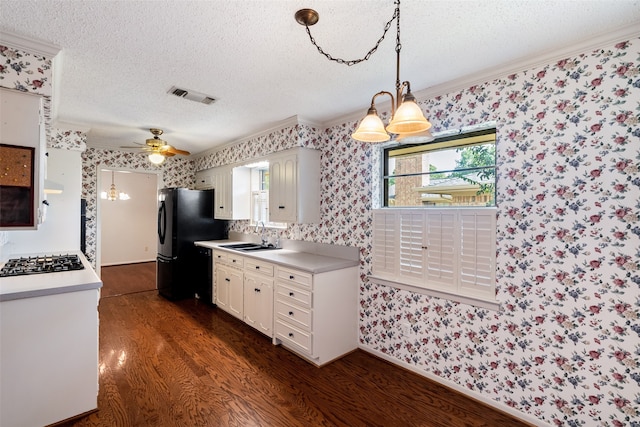 kitchen featuring ceiling fan, dark wood-type flooring, plenty of natural light, and ornamental molding