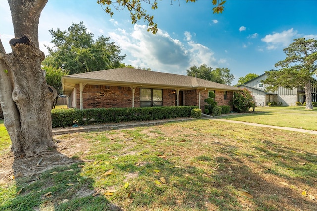 single story home with brick siding and a front yard