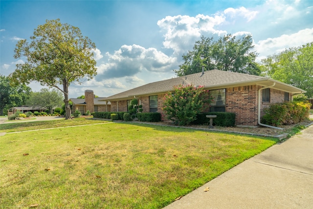 ranch-style home with a front lawn