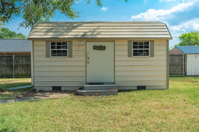 view of shed featuring fence