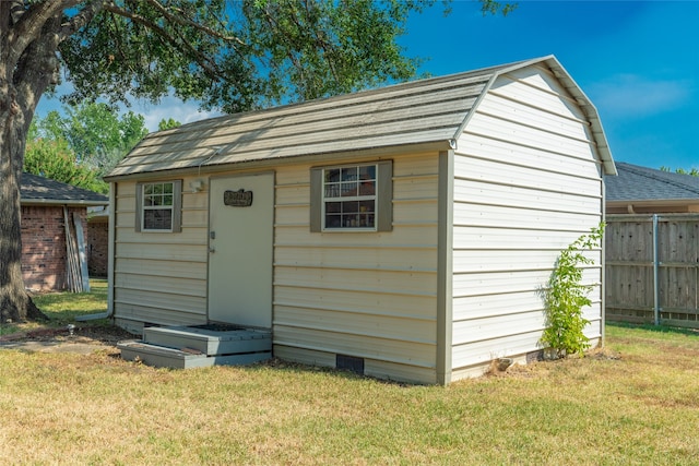 view of outbuilding featuring a lawn