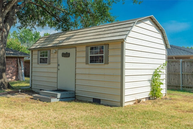 view of shed featuring fence