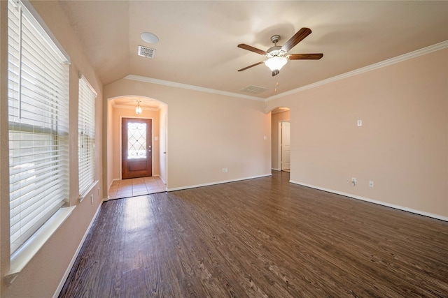 interior space featuring lofted ceiling, dark hardwood / wood-style floors, ornamental molding, and ceiling fan