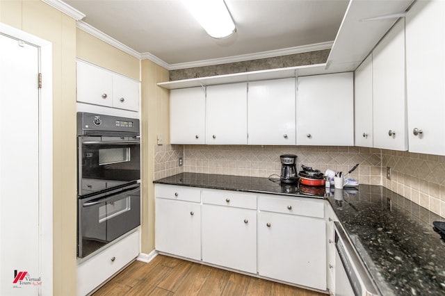 kitchen featuring white cabinets, hardwood / wood-style flooring, black double oven, and crown molding