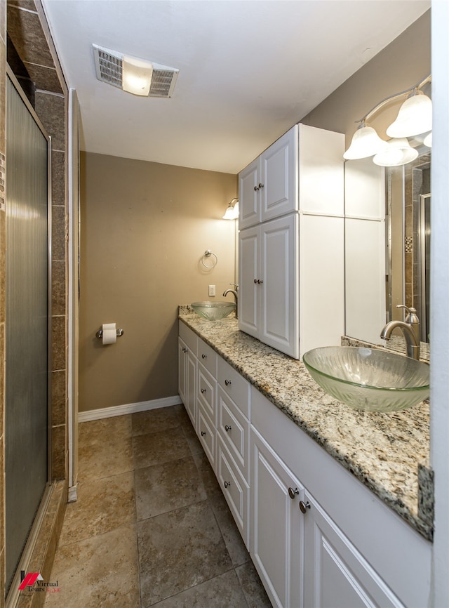 bathroom with an enclosed shower and vanity