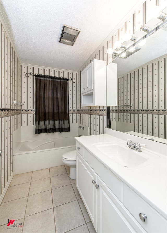 bathroom featuring tile patterned floors, a textured ceiling, vanity, and toilet