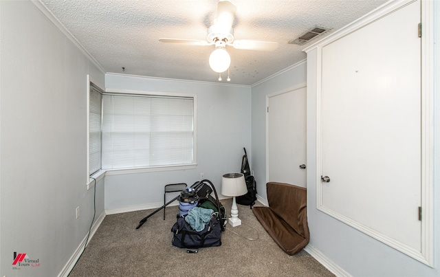 sitting room with ceiling fan, a textured ceiling, crown molding, and carpet flooring