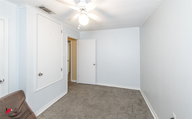 interior space with a textured ceiling, ornamental molding, and ceiling fan