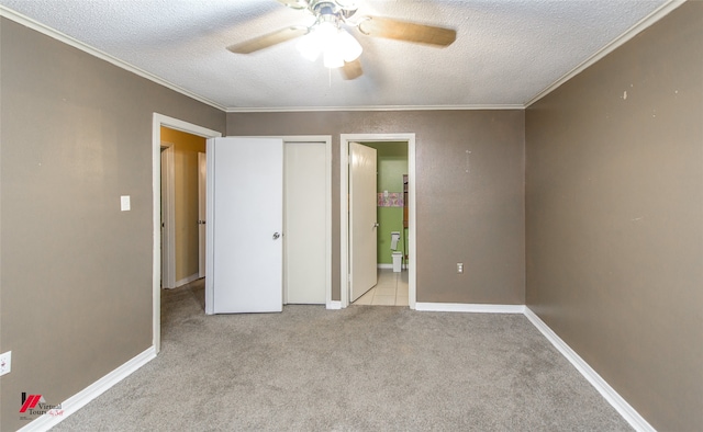 unfurnished bedroom featuring light carpet, ceiling fan, crown molding, and a textured ceiling