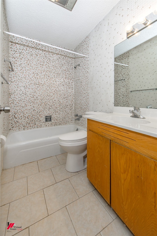 full bathroom with tiled shower / bath, vanity, toilet, and tile patterned floors