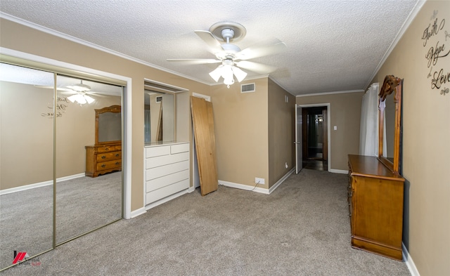 unfurnished bedroom with a textured ceiling, crown molding, light carpet, and ceiling fan