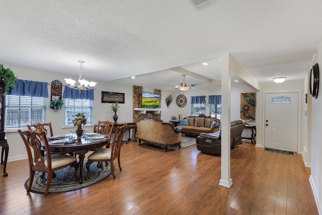 dining space featuring hardwood / wood-style flooring, plenty of natural light, and a textured ceiling