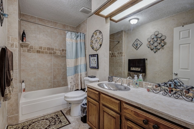 full bathroom with toilet, a textured ceiling, tile patterned flooring, vanity, and shower / tub combo