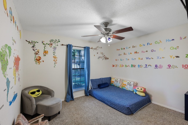 carpeted bedroom with a textured ceiling and ceiling fan