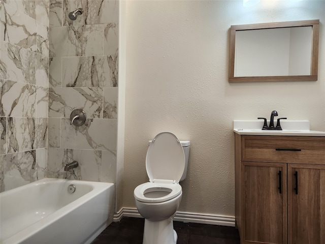 full bathroom featuring vanity, tiled shower / bath combo, and toilet