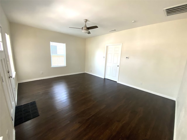 unfurnished room with ceiling fan and dark wood-type flooring