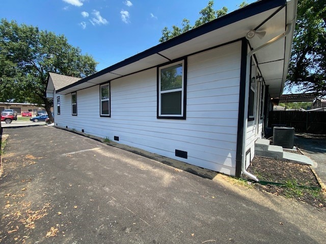 view of side of home featuring cooling unit