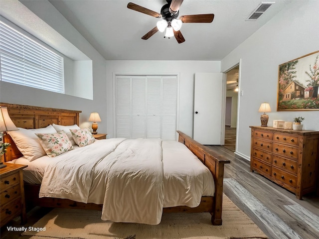 bedroom featuring light hardwood / wood-style flooring, ceiling fan, and a closet