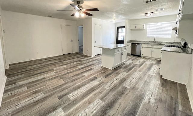 kitchen featuring dishwasher, white cabinetry, and wood-type flooring