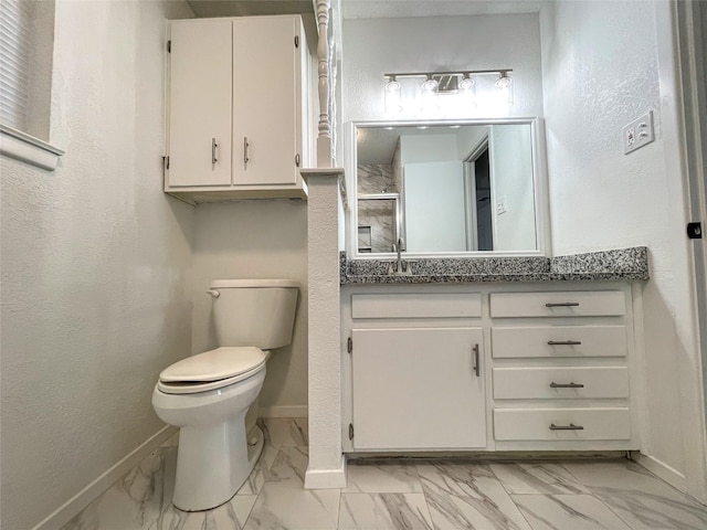 bathroom featuring a shower with door, vanity, and toilet