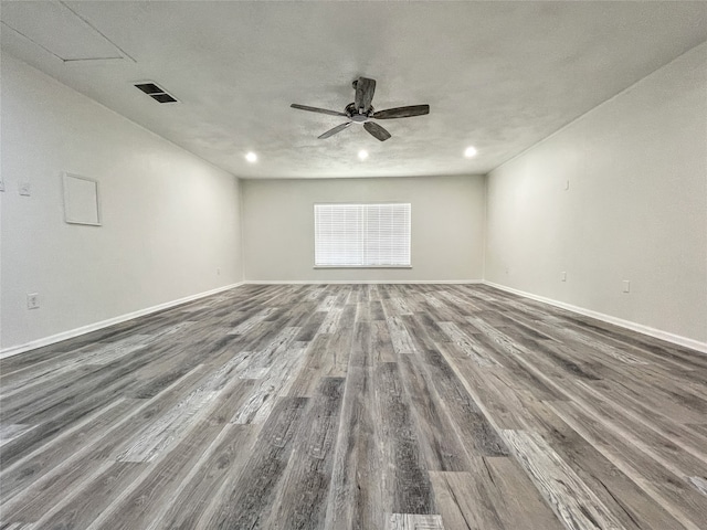 empty room with ceiling fan and dark hardwood / wood-style floors