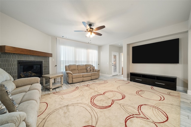 living room with ceiling fan and light wood-type flooring