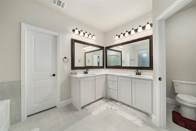 bathroom featuring toilet, a washtub, and vanity